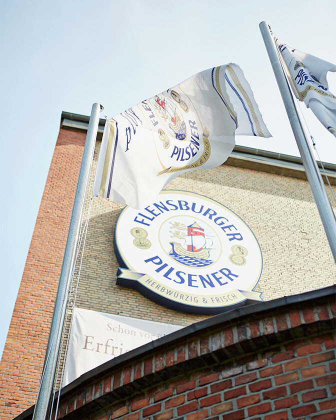 Flensburger flags and logo on the house wall